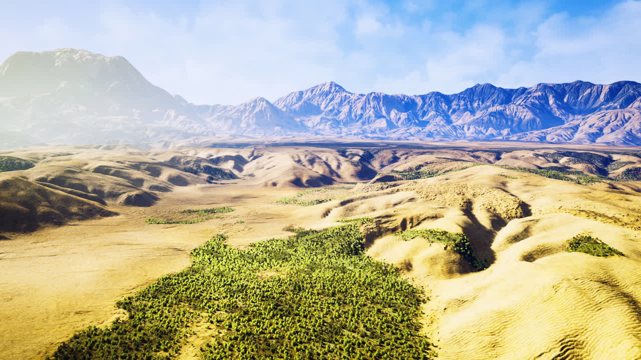 Vast desert terrain meets a lush green area in a breathtaking natural setting