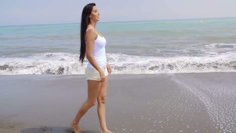 Woman-Walking-Along-Shore-of-Tropical-Beach