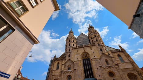 vienna, austria - june 9, 2025: entrance façade of the saint stephen's cathedral. distancing from a landmark by the street of old town in vienna, austria. low angle view