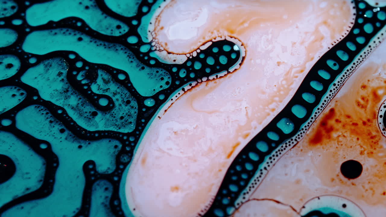 Liquid mixing in a colorful macro shot showing vibrant fluid dynamics and bubbles