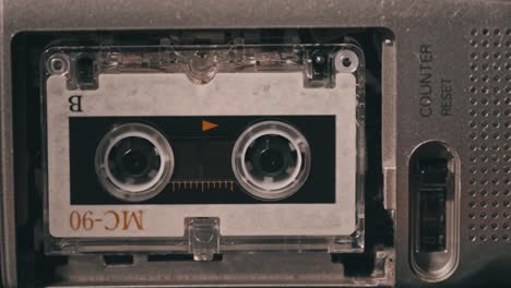 vintage audio tape with a blank label spinning in cassette recorder, close-up