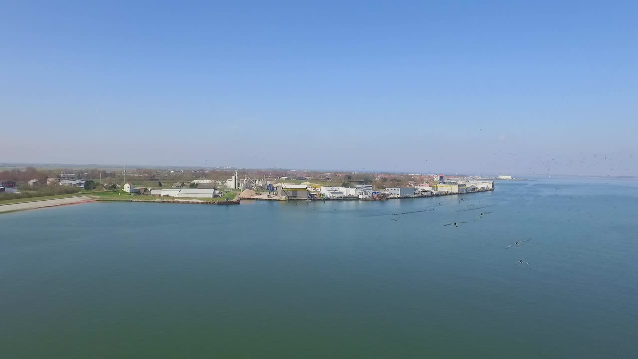 Coastal View with Birds and Industrial Area