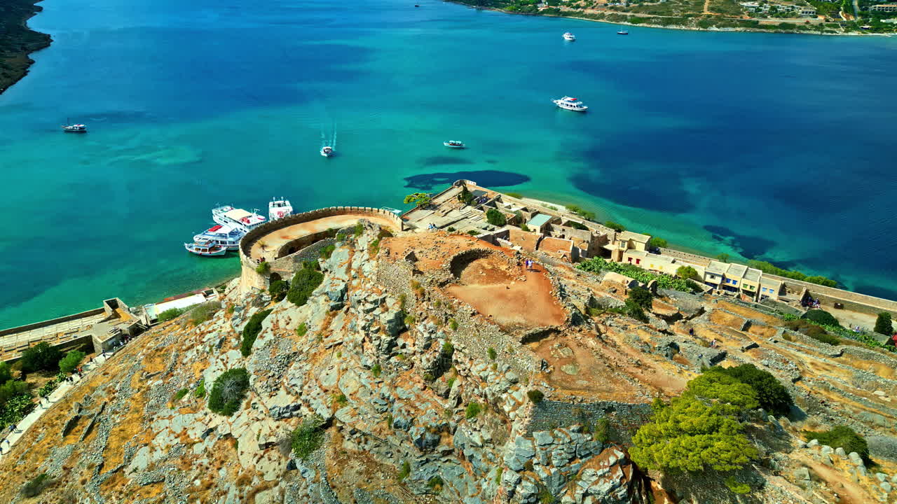 Aerial overview of Spinalonga Fortress on Crete Island, with panoramic views of the surrounding sea and coastline