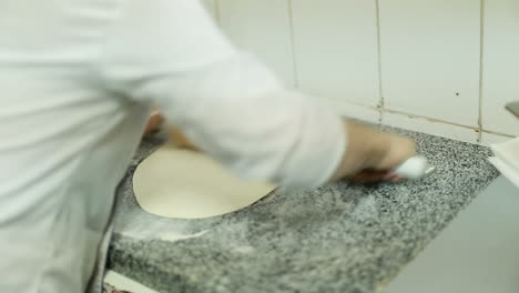 chef baker cook pizza. closeup hand of chef baker making pizza at kitchen