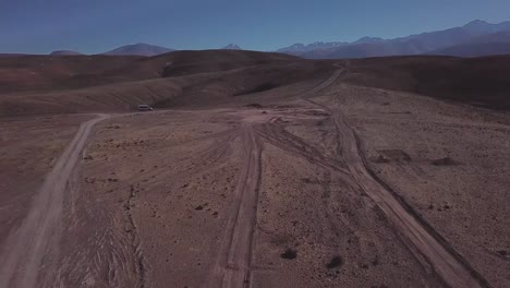 a car driving through the wild deserted landscape of atacama desert, chile, scenic road journey, bolivia