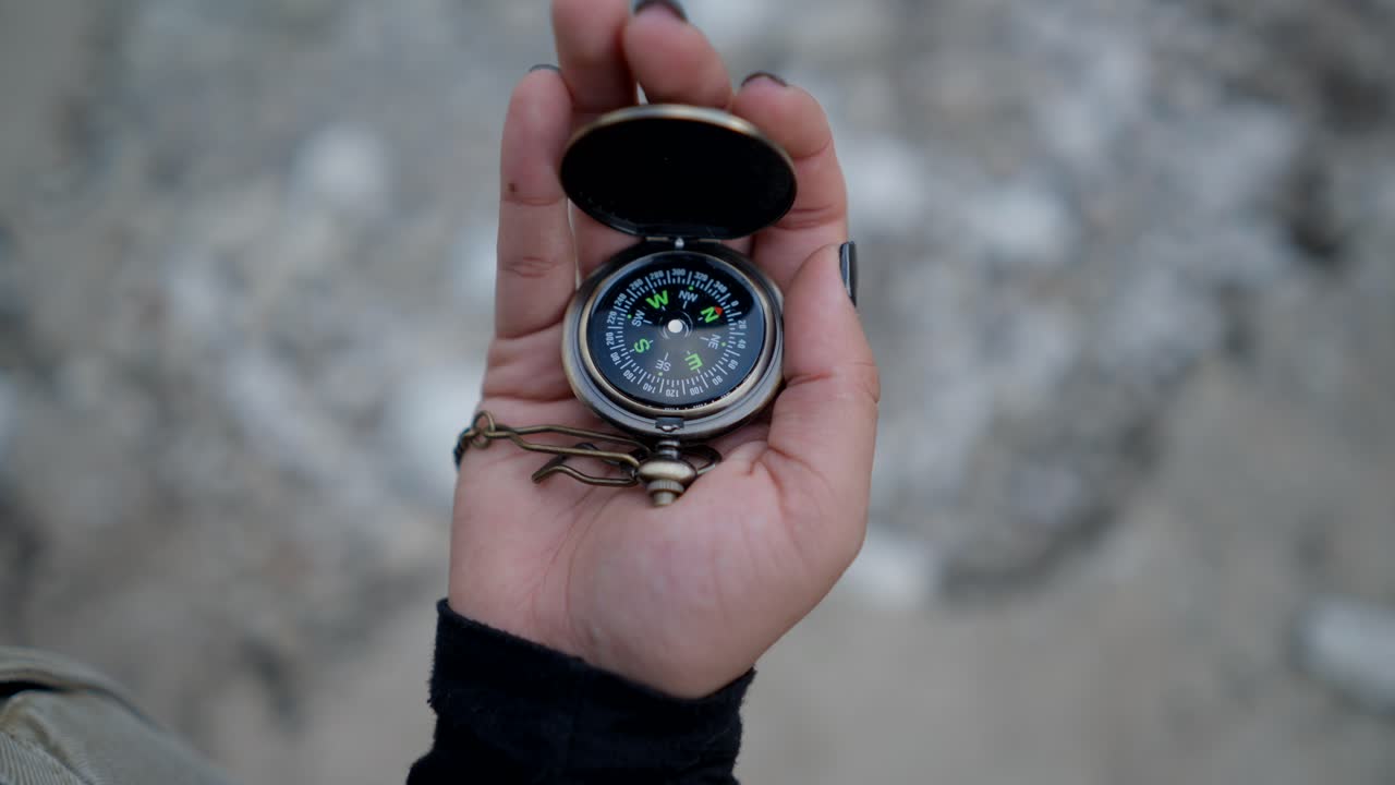 Hand Holding a Pocket Compass