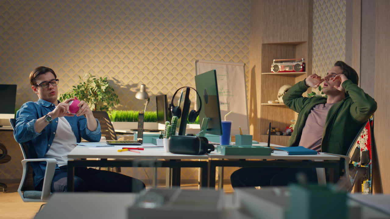 편안한 사람들이 브레이크 크리에이티브 오피스를 즐기고, 디자이너들이 공을 던지는 재미를 느다.