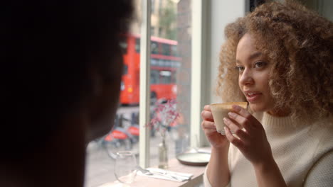 Stylish-Young-Couple-Enjoying-Drink-In-Coffee-Shop