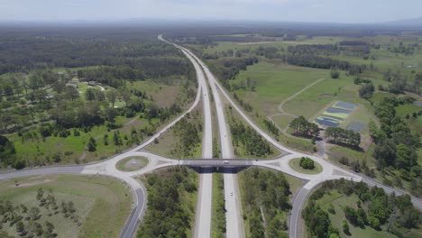 Aerial-View-Of-Vehicles-Driving-Through-Pacific-Highway-And-Macleay-Valley-Way-In-NSW,-Australia
