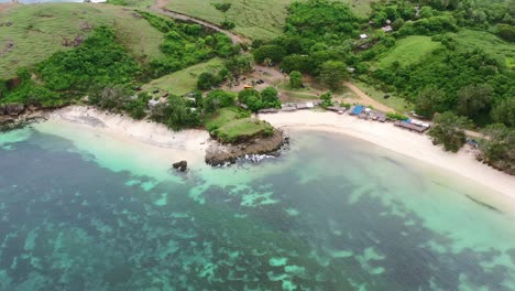 beautiful emerald green coral reef coastline with tropical white sand beach at bukit merese lombok, aerial