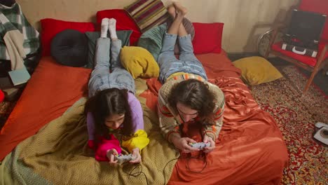 couple playing video games in bed