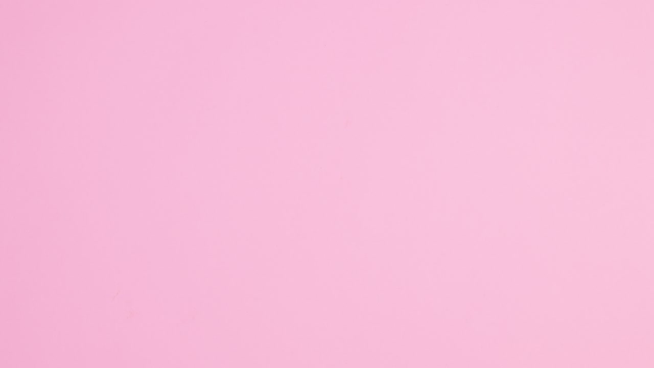 Manicure tools and nail polish bottles appear on bright pink background. Creative layout of manicure tools. Stop motion flay lay