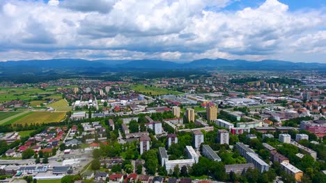 aerial view above green town of celje slovenia blue sky above mountains in clean neighborhood in east european summer weather