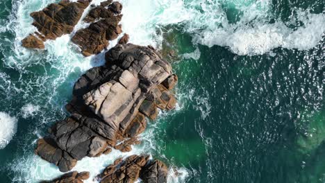 Overhead-drone-aerial-rocks-in-clear-blue-sea-off-Jersey-channel-islands