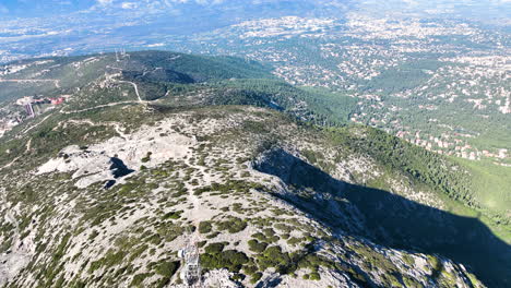 aerial footage of telecommunication towers on the slopes of a mountain