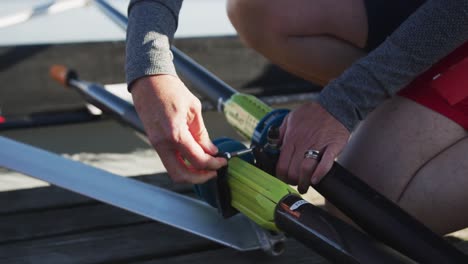 senior caucasian woman preparing rowing boat in a river