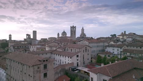ascensional shot of the medieval village of bergamo alta with the building of the old "sant'agata" prisons
