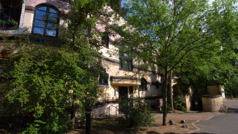 Forest-Spiral-Waldspirale-Darmstadt-Hundertwasser-famous-colorful-germany-facade-house-entrance-on-a-sunny-day-steady-gimbal-shot-blue-sky-1