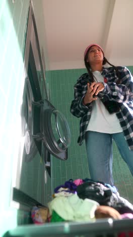 teenager doing laundry at a self-service laundromat