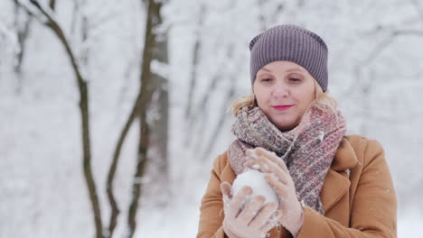 A-Woman-Sculpts-A-Snowball-And-Throws-It-In-The-Direction-Of-The-Camera-Winter-Fun