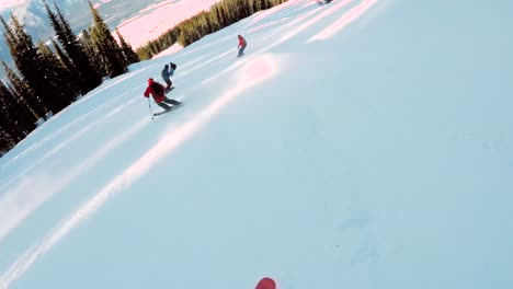 skiers skiing down a snowy hill 4k