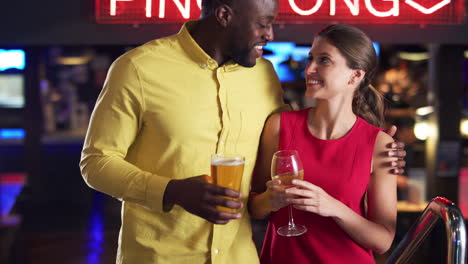 couple climbing stairs as they meet for drinks and socialize in bar