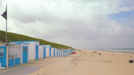 wooden buildings on a beach in the netherlands on the island of texel