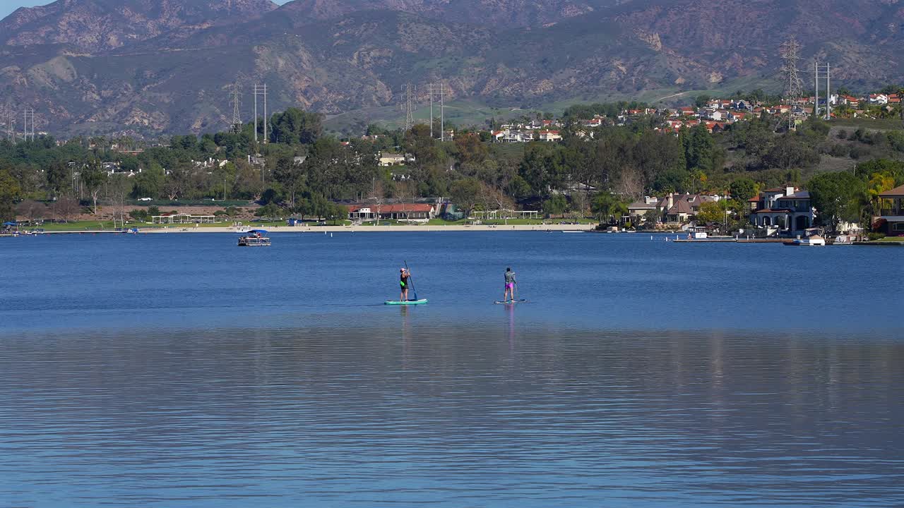 Two female paddle boarders on Lake Mission Viejo in Southern California