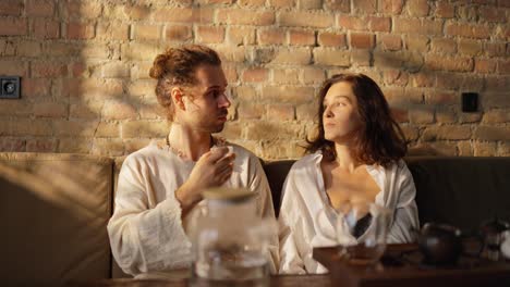 couple enjoying tea together in a cozy living room