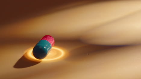 close-up of a teal and pink capsule