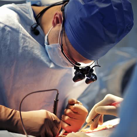 male neurosurgeon with hi tech equipment provide operation on the patient. serious doctor in operation room