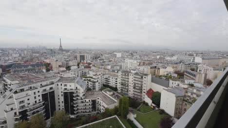 wide view of paris with eiffel tower in distance, push-in from balcony