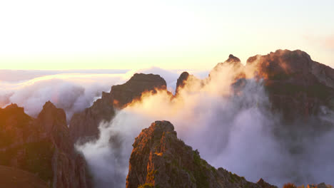 epic sunset landscape in the beautiful mountains covered with clouds, madeira island