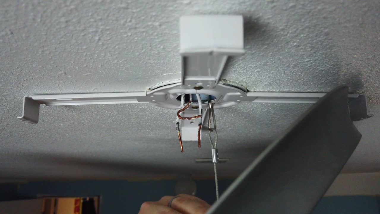 Installing a brand new LED light mount for a light upgrade and hooking the safety line to hang and start twisting the wires together
