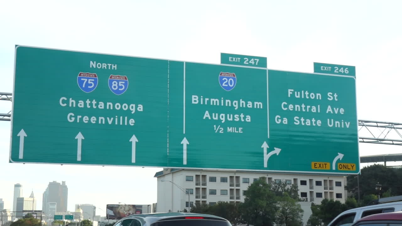 Moving shot from Atlanta downtown freeway with highway signs B-roll