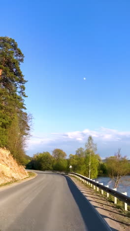 scenic country road by a river with moon
