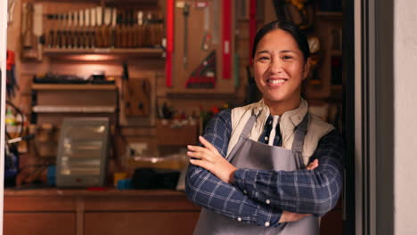 Tools,-arms-crossed-and-face-of-woman-in-workshop