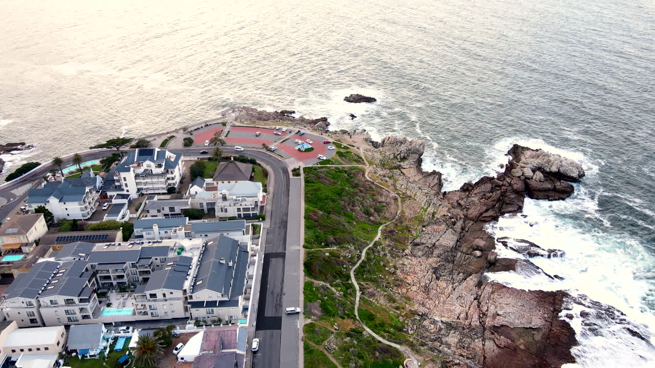 Scenic coastal cliff path with ocean view on rugged Hermanus coastline, aerial