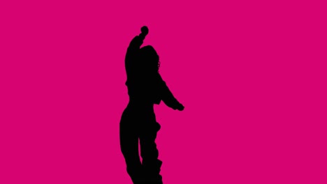 studio silhouette of woman dancing against pink background