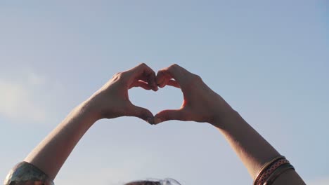 woman's hands making heart shape