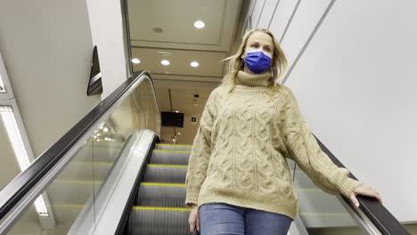 shopping during the times of covid-19 woman on escalator