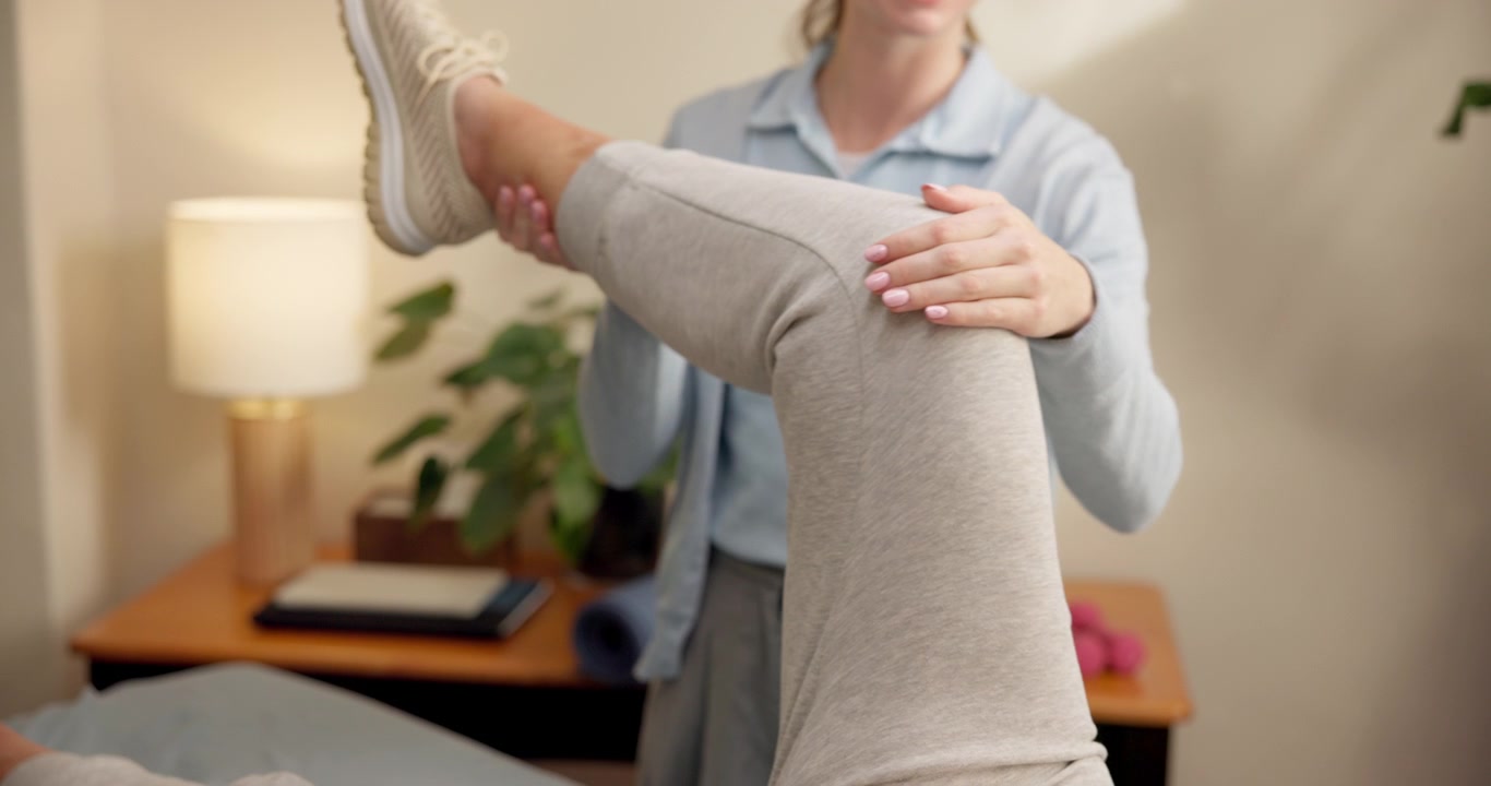Physical Therapist Performing Leg Stretching Exercise on Patient