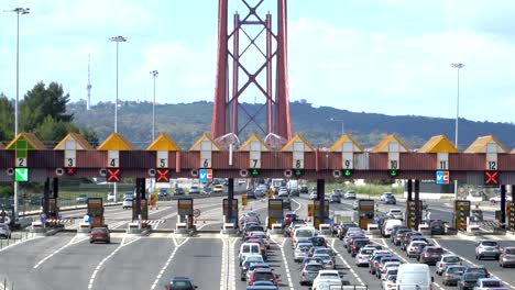 cars passing through the point of toll highway, toll station near the bridge. lisbon, portugal