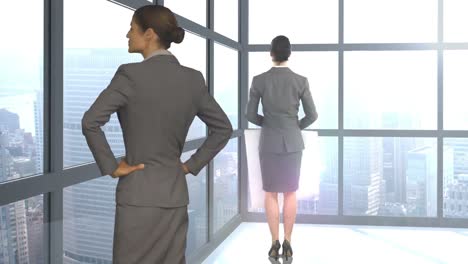 Digital-image-of-businesswomen-are-standing-and-looking-away-by-window