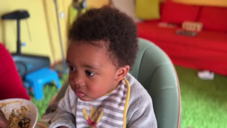 exotic two year old afroeuropean child eating african food