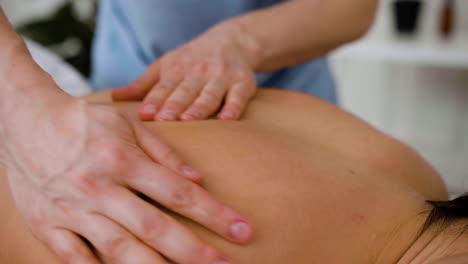 person giving a back massage