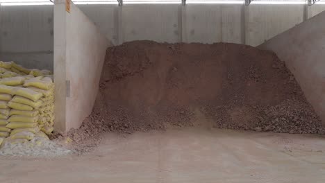 cement bags and clay storage in a factory warehouse