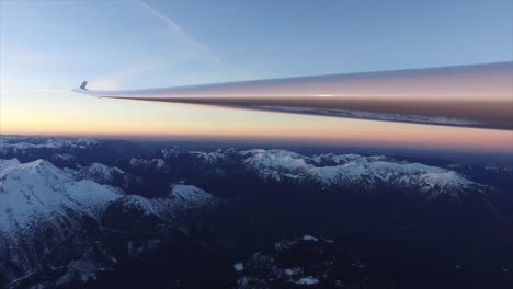 wing of a glider pilot flying over the alps between austria and germany
