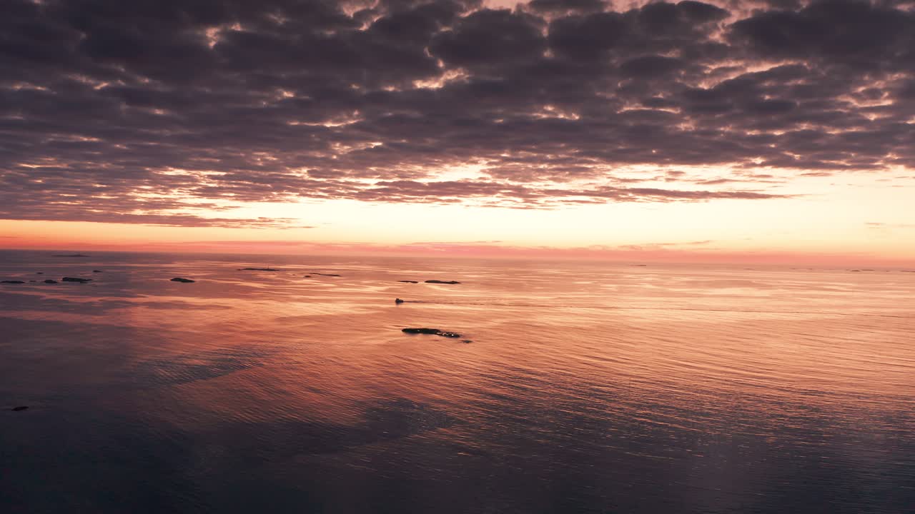 A picturesque landscape of a pink-hued sunset over still waters, creating a serene and peaceful atmosphere