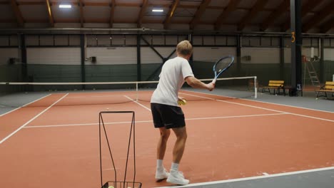 man playing tennis indoor